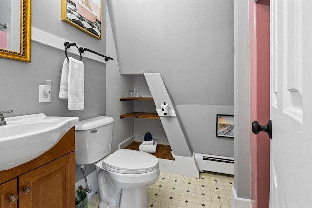 bathroom featuring a baseboard radiator, vanity, and toilet