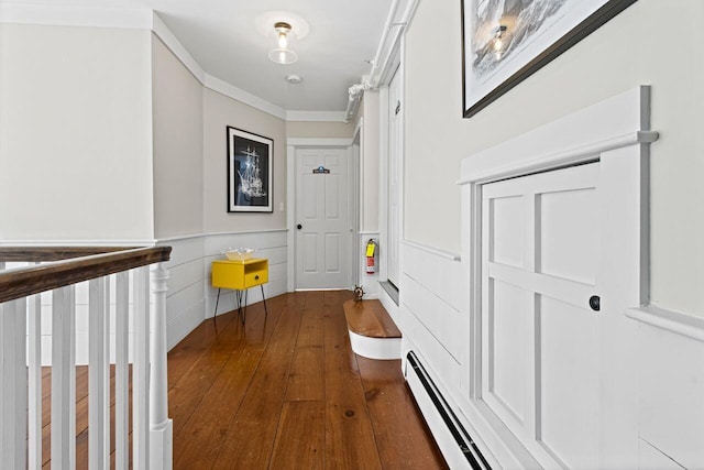 corridor with ornamental molding and dark wood-type flooring