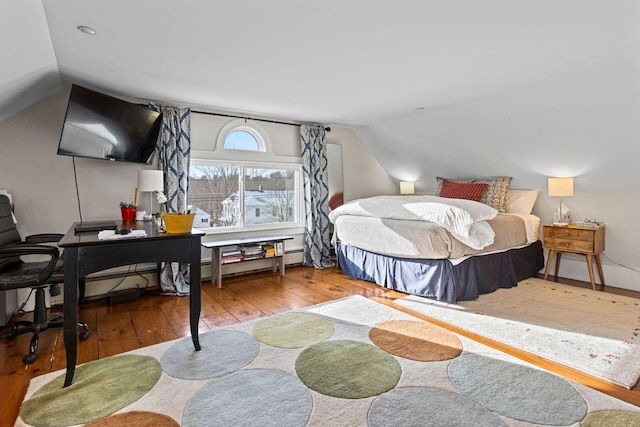 bedroom featuring vaulted ceiling and hardwood / wood-style floors