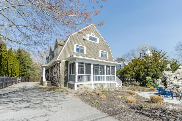 61 Fletcher St, Kennebunk, ME 04043 - exterior space featuring a sunroom, a gambrel roof, and fence
