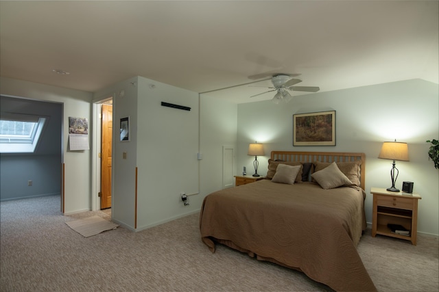 carpeted bedroom featuring ceiling fan and a skylight