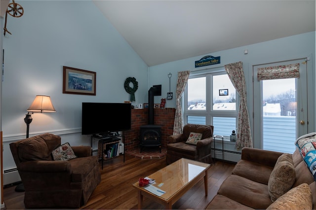 living room with lofted ceiling, a baseboard heating unit, dark wood-type flooring, and a wood stove