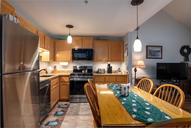 kitchen with light stone counters, sink, hanging light fixtures, and black appliances