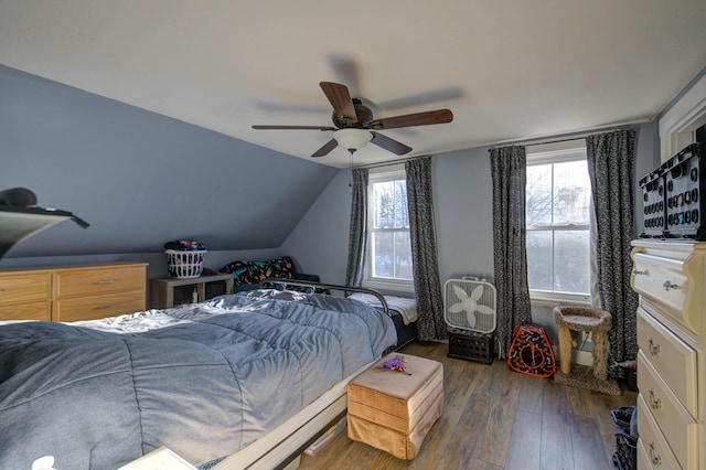 bedroom featuring vaulted ceiling, dark hardwood / wood-style floors, and ceiling fan