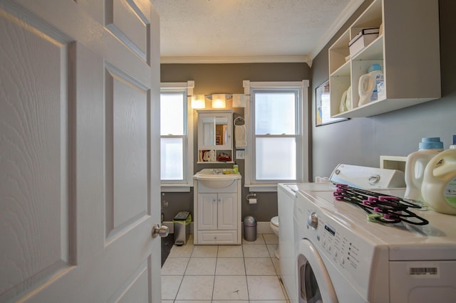 laundry room featuring plenty of natural light, ornamental molding, a textured ceiling, and light tile patterned flooring