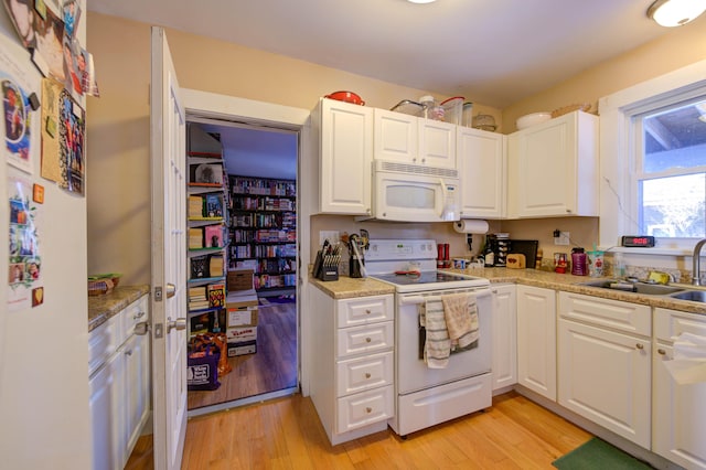 kitchen featuring light stone counters, white appliances, light hardwood / wood-style flooring, and white cabinets