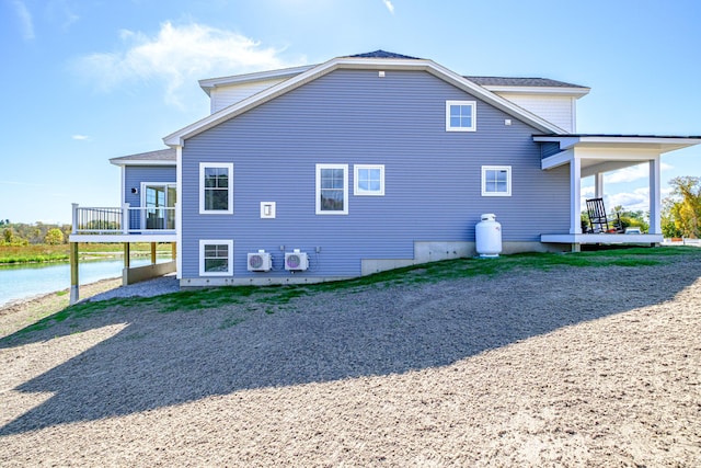 view of side of home with a water view