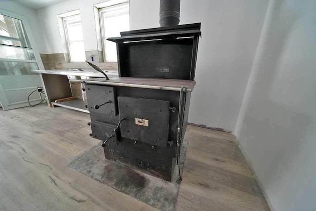 interior details featuring backsplash and wood-type flooring