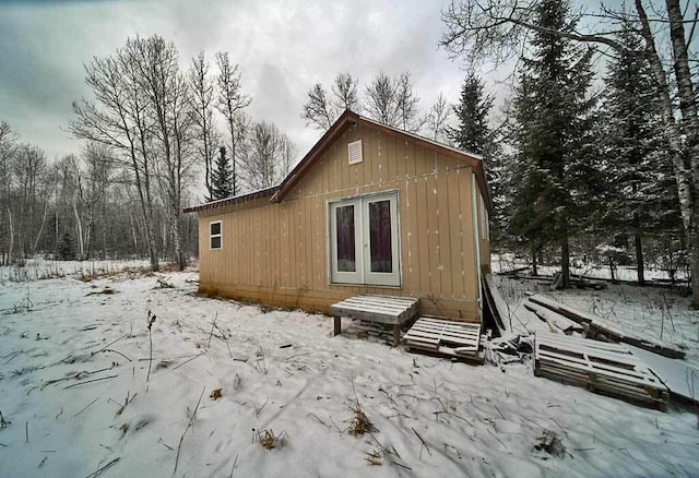 view of snow covered back of property