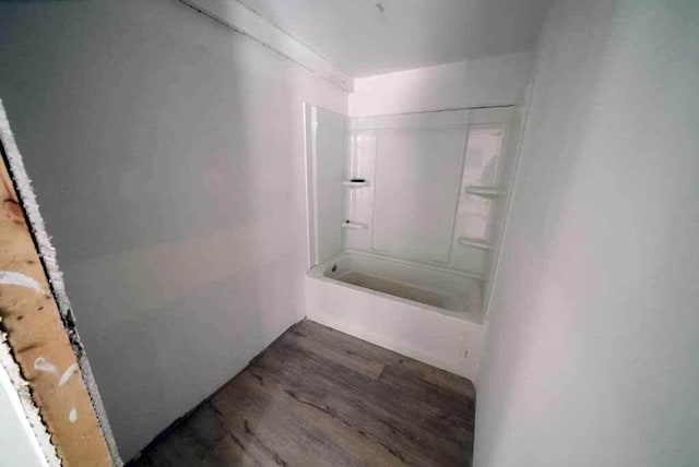 bathroom featuring  shower combination and hardwood / wood-style flooring