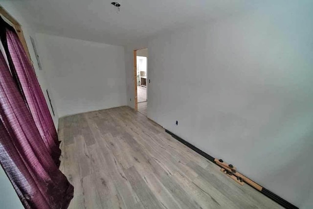 spare room with light hardwood / wood-style floors