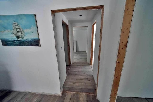 hallway with wood-type flooring