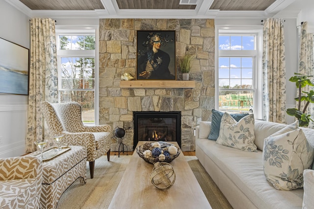 sitting room featuring ornamental molding and a stone fireplace