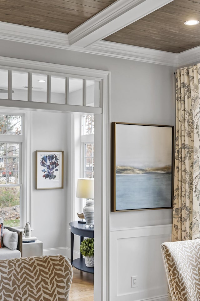 doorway featuring crown molding, a wealth of natural light, wood ceiling, and hardwood / wood-style floors