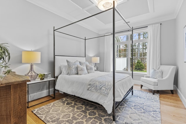 bedroom with wood-type flooring, crown molding, and multiple windows