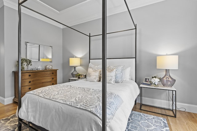 bedroom with crown molding and wood-type flooring