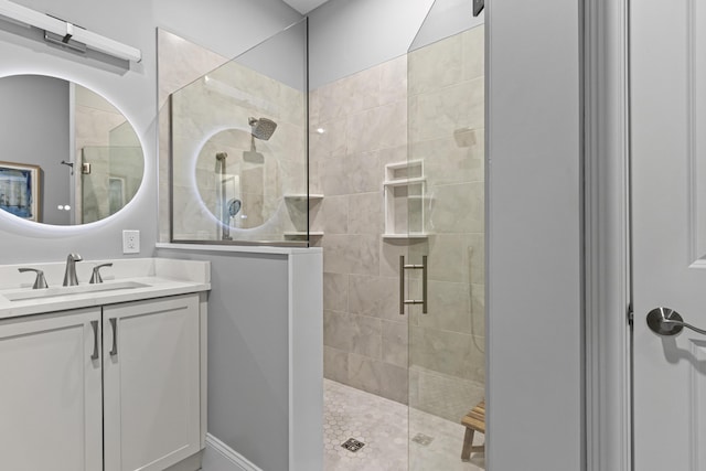 bathroom with a shower with door and vanity