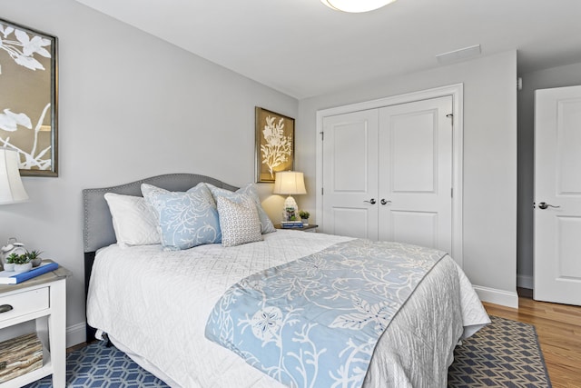 bedroom featuring dark wood-type flooring and a closet