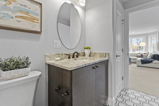 bathroom with toilet and vanity