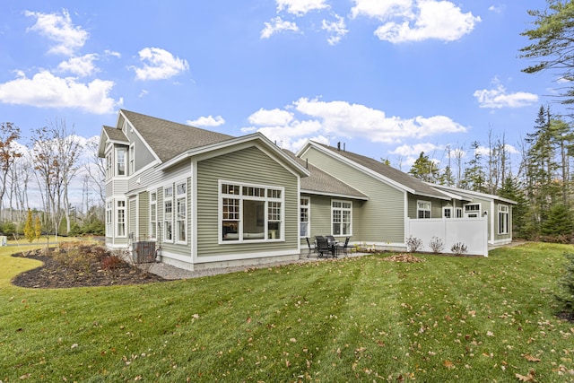 back of property featuring a yard, a patio, and central air condition unit