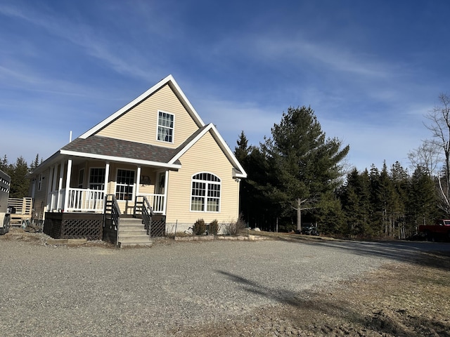 view of front of property with covered porch and roof with shingles