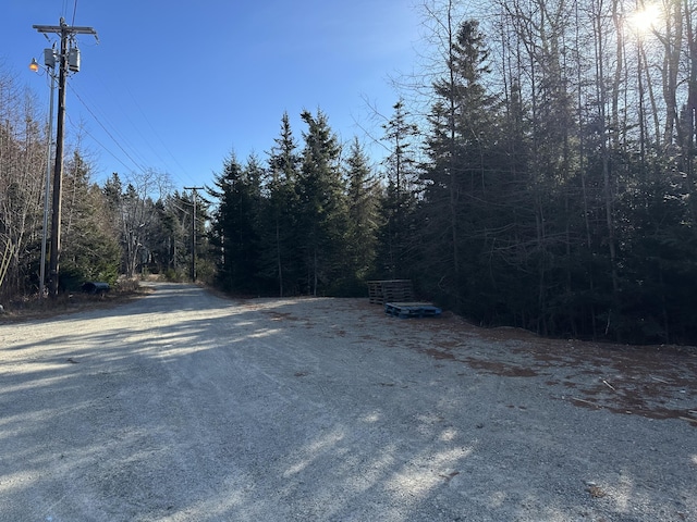 view of road with a forest view