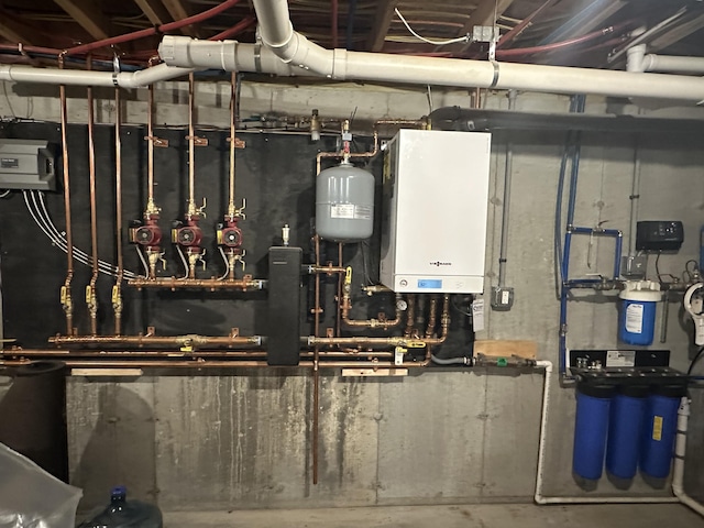 utility room featuring water heater