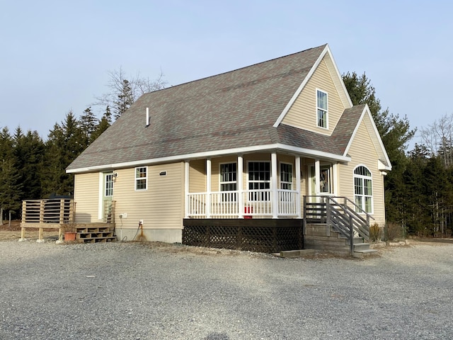 view of front of property with a porch and roof with shingles