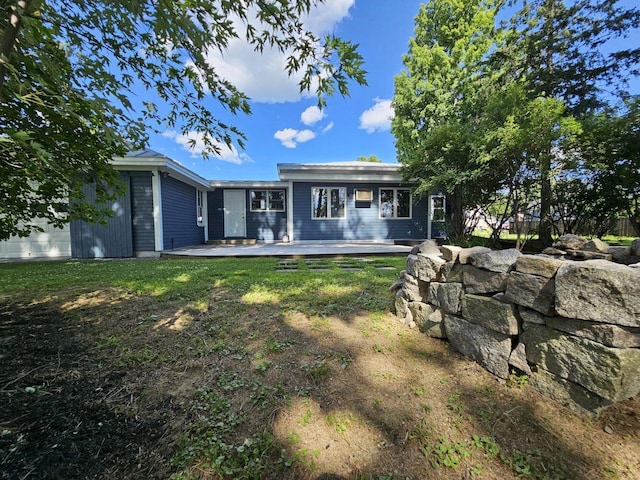 back of house with a lawn