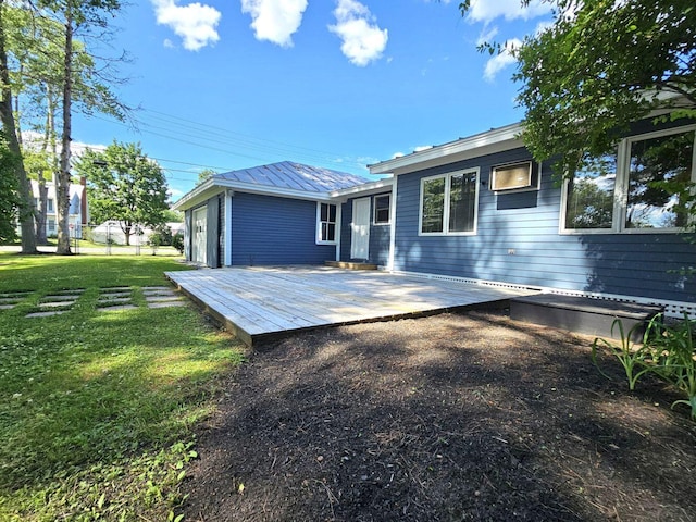 rear view of house with a deck and a lawn