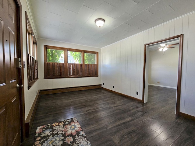 unfurnished room featuring dark wood-type flooring and ornamental molding