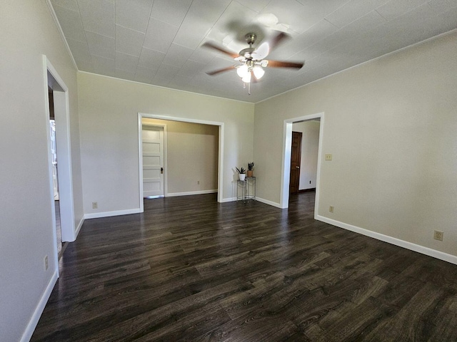 spare room featuring ceiling fan and dark wood-type flooring