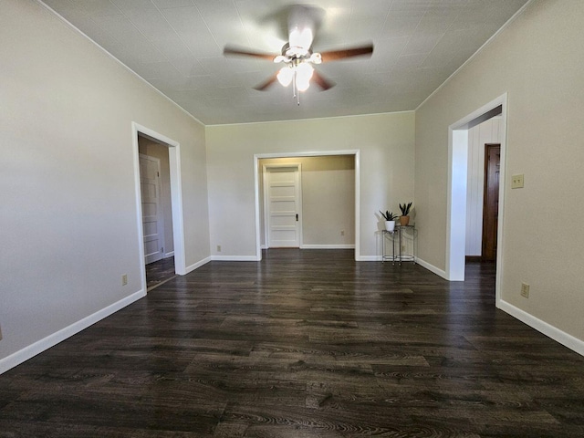 unfurnished room featuring ceiling fan and dark wood-type flooring