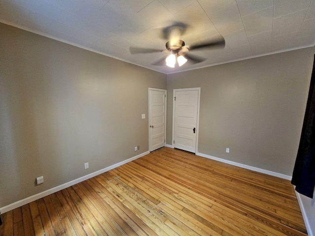 spare room featuring ceiling fan, wood-type flooring, and ornamental molding