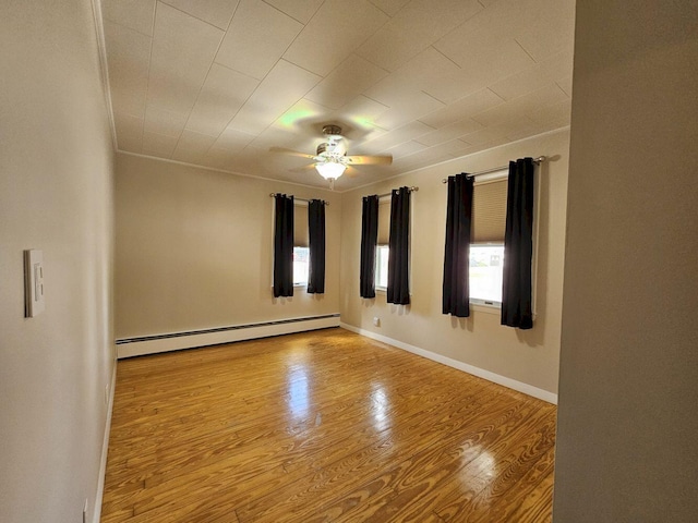 unfurnished room with ceiling fan, a baseboard heating unit, and light hardwood / wood-style floors