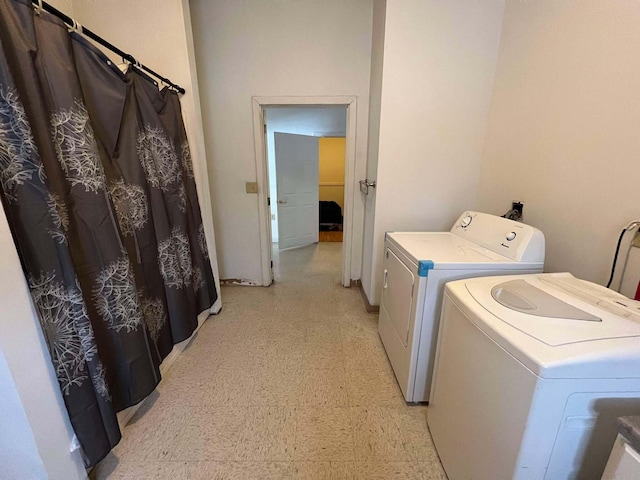 clothes washing area featuring separate washer and dryer