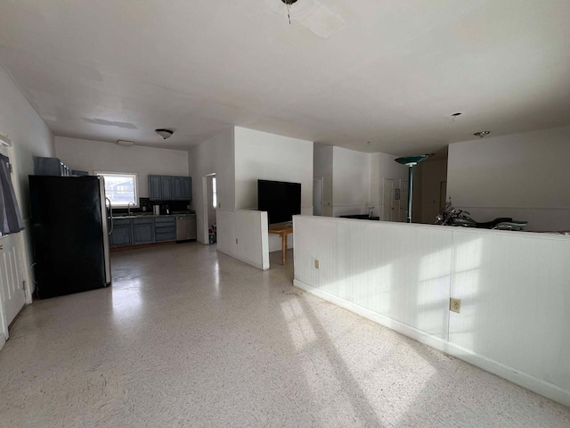 unfurnished living room featuring sink