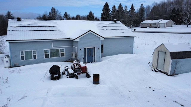 view of snow covered rear of property