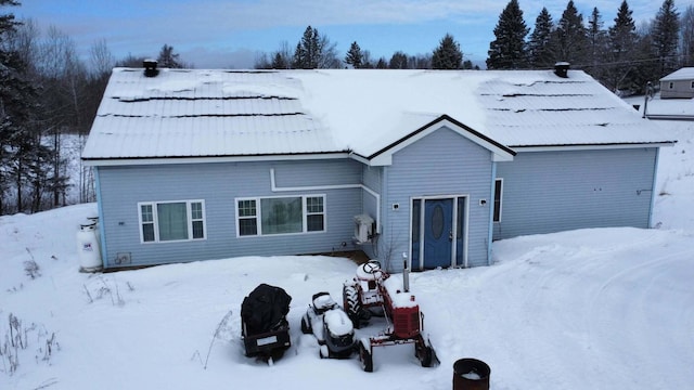 view of snow covered back of property