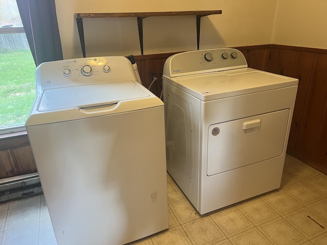 washroom featuring washer and dryer and wood walls