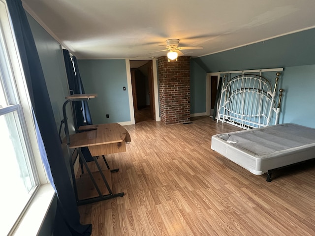 bedroom with hardwood / wood-style flooring, lofted ceiling, and ceiling fan