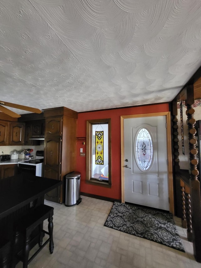 foyer entrance featuring a textured ceiling