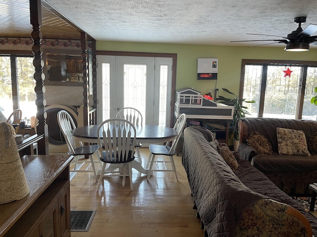 dining area featuring ceiling fan, plenty of natural light, and a textured ceiling