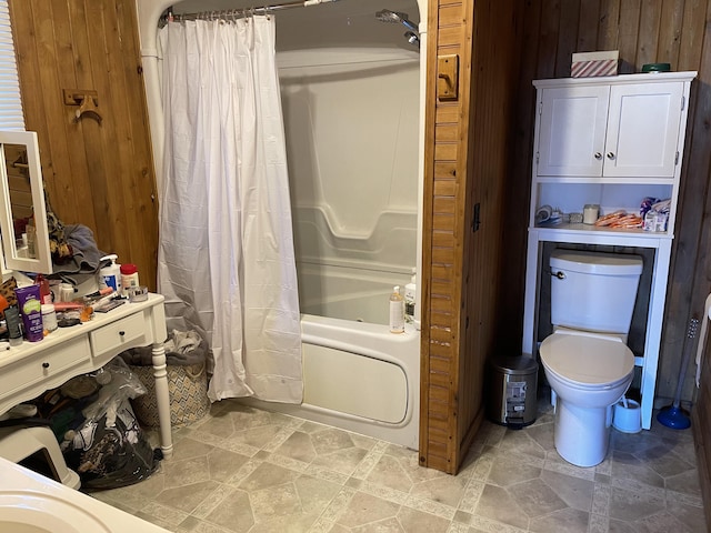 bathroom with toilet, wooden walls, and shower / bath combination with curtain