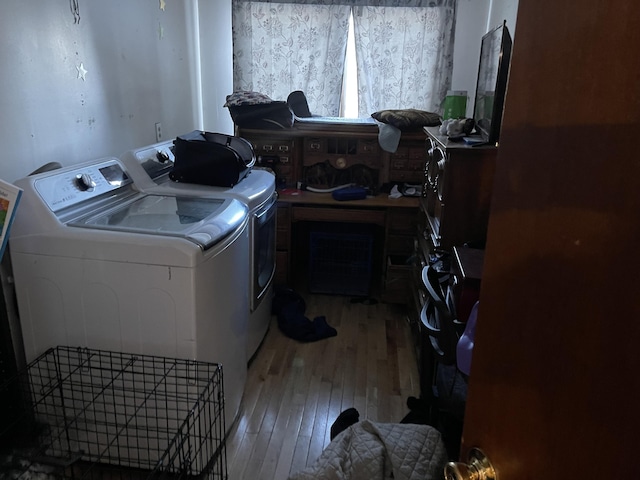 washroom with independent washer and dryer and hardwood / wood-style flooring