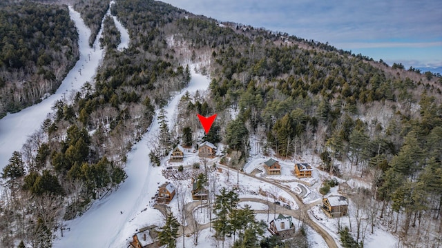 snowy aerial view with a mountain view