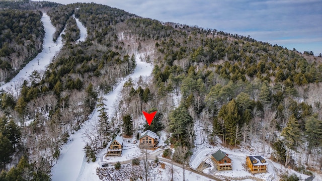 snowy aerial view featuring a mountain view