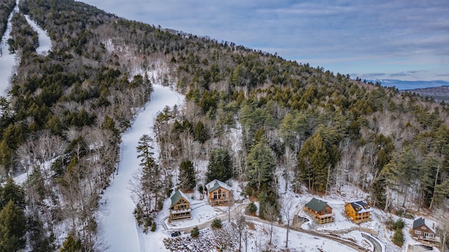 snowy aerial view with a mountain view