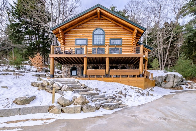 log cabin with a wooden deck