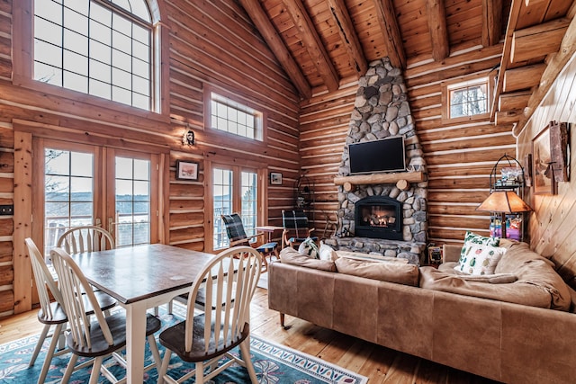 interior space featuring log walls, wood ceiling, beamed ceiling, a water view, and high vaulted ceiling